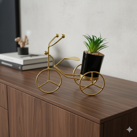 Gold decorative bike sculpture with a plant 