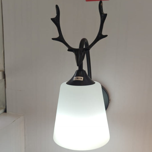 Wall-mounted light fixture with deer antler design.