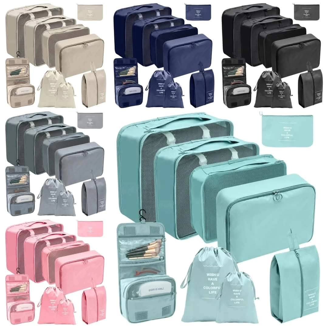 Nine piece set of luggage travel organizer cubes and bags in multiple colors including black, navy blue, pink, grey, and mint green.