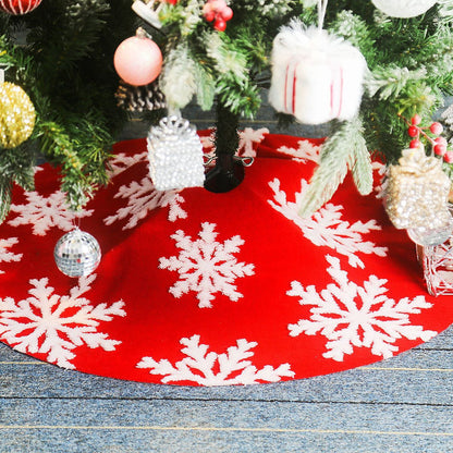 Festive red Christmas tree skirt with large white embroidered snowflakes