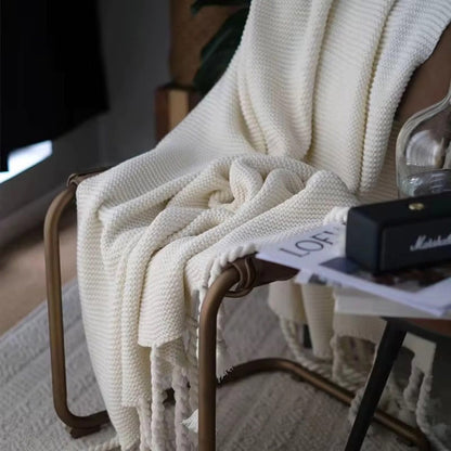 White blanket draped over a chair 