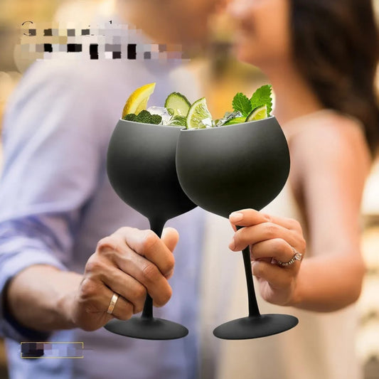 A couple toasting with two matte black stemmed wine glass goblets.