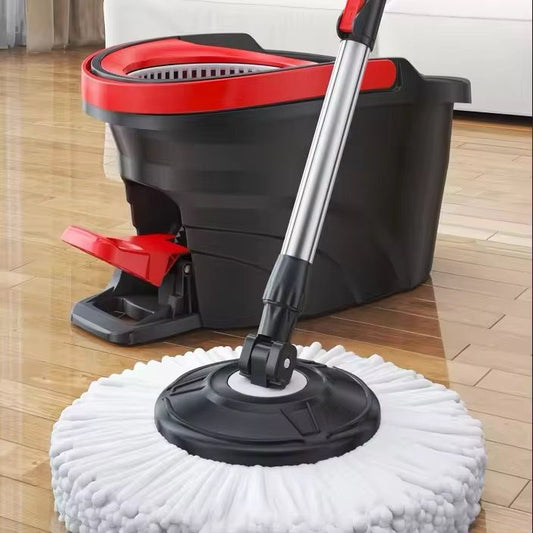 A black and red spin mop bucket with a foot pedal, showing a large white microfiber mop head attached to a silver metal handle resting on a shiny wood floor.