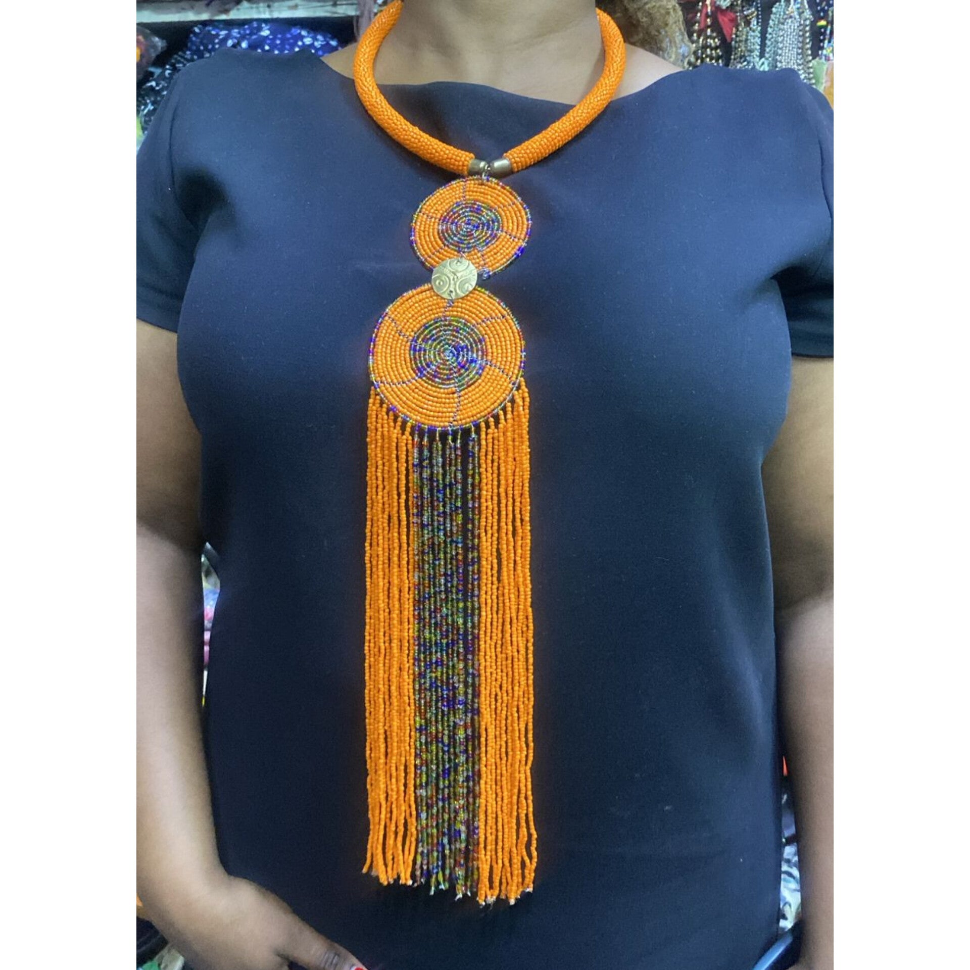 Maasai beaded necklace with a large double-circle pendant and long, multi-strand dangling tassels,