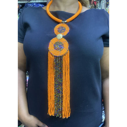 Maasai beaded necklace with a large double-circle pendant and long, multi-strand dangling tassels,