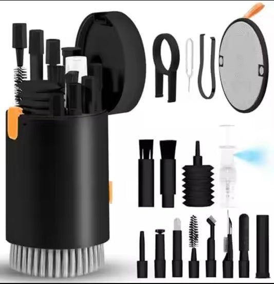 A black and orange cylindrical gadget cleaning set opened to show various small black brushes, tools, an air blower, a spray bottle, and a round mirror or screen cleaner attached.