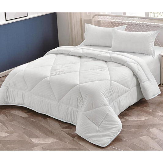 A perfectly made bed with a white quilted duvet comforter, white bed sheet, and two white pillows, styled in a modern bedroom setting.