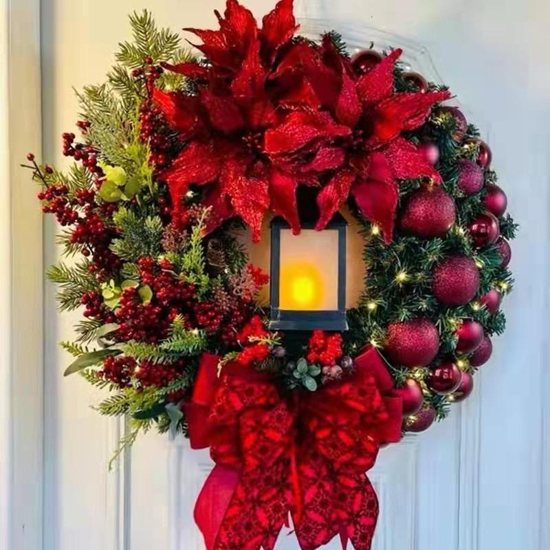 40cm Christmas wreath with red poinsettias, ornaments, berries, a red and gold bow, and a glowing central lantern.