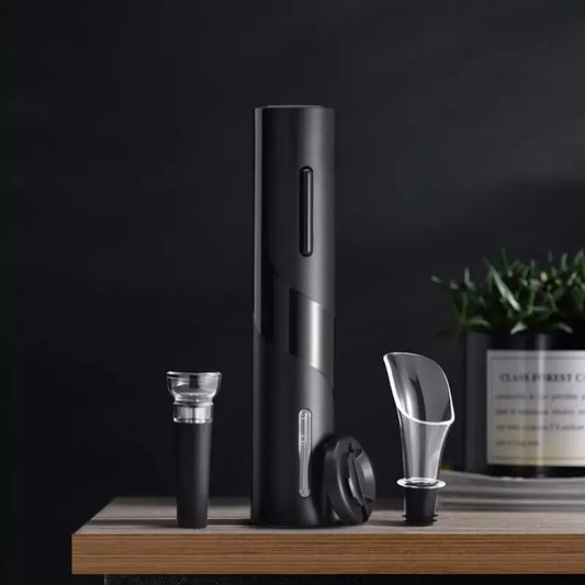 A battery operated modern wine opener gift set displayed on a table, including a foil cutter, corkscrew, vacuum stopper, and wine pourer.