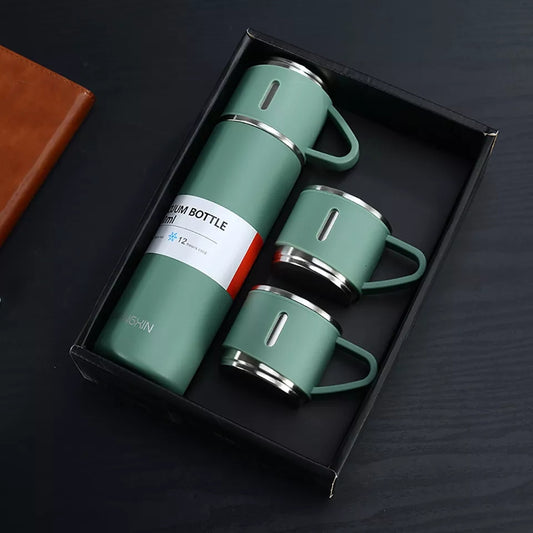 A high quality gift set featuring a green stainless steel 500ml vacuum flask and three matching handled cups, arranged neatly inside a black presentation box.