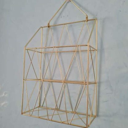 Golden wall mounted magazine rack