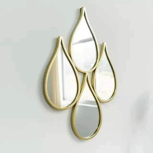Four teardrop-shaped mirrors with gold frames arranged in a row 