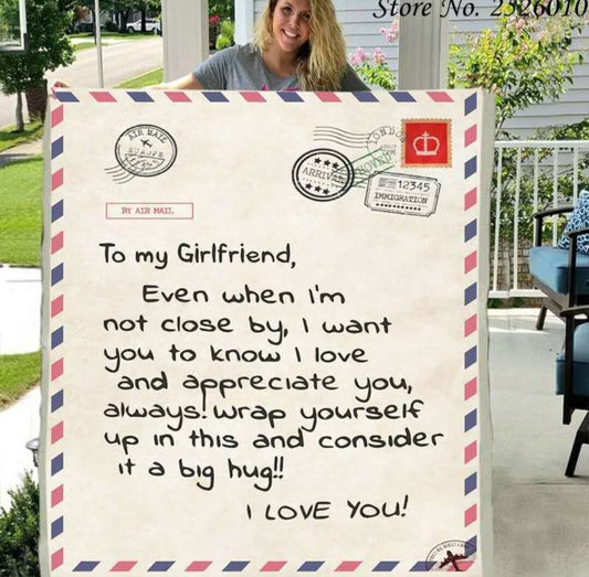 A cozy throw blanket designed to look like a giant air mail letter, featuring a handwritten message.